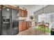 Kitchen features dark wood cabinets and black appliances at 1153 Legatto Loop, Dundee, FL 33838
