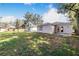 Spacious backyard with grassy area and mature trees at 124 A St, Haines City, FL 33844