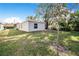 House backyard with grassy area and a tree at 124 A St, Haines City, FL 33844