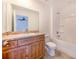 Bathroom with wood vanity, shower, and toilet at 124 A St, Haines City, FL 33844