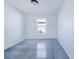 Bright bedroom with large window and polished concrete floors at 124 A St, Haines City, FL 33844