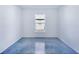 Simple bedroom with large window and concrete floor at 124 A St, Haines City, FL 33844