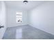 Bright bedroom with a window and concrete floors at 124 A St, Haines City, FL 33844