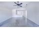 Open living room with concrete floors and ceiling fan at 124 A St, Haines City, FL 33844