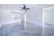 Open living room with concrete floors and ceiling fan at 124 A St, Haines City, FL 33844