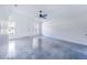 Open living room with concrete floors and ceiling fan at 124 A St, Haines City, FL 33844