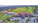 Aerial view showcasing the clubhouse, golf course, and parking area at 1932 Southern Dunes Blvd, Haines City, FL 33844