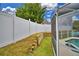 Landscaped backyard with privacy fence and wooden retaining wall at 1932 Southern Dunes Blvd, Haines City, FL 33844