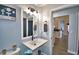 Bathroom with pedestal sink and view into kitchen at 1932 Southern Dunes Blvd, Haines City, FL 33844