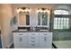 Elegant bathroom with double vanity and black countertop at 1932 Southern Dunes Blvd, Haines City, FL 33844