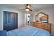 Bedroom with dresser, double doors, and ceiling fan at 1932 Southern Dunes Blvd, Haines City, FL 33844