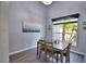 Dining room with gray walls, wood-look floors, and large window at 1932 Southern Dunes Blvd, Haines City, FL 33844