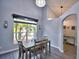 Bright dining room with gray walls, wood-look floors, and chandelier at 1932 Southern Dunes Blvd, Haines City, FL 33844