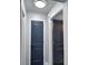 Clean hallway with updated dark blue doors and recessed lighting at 1932 Southern Dunes Blvd, Haines City, FL 33844