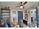 Home office features a glass desk, built-in shelving, and ceiling fan at 1932 Southern Dunes Blvd, Haines City, FL 33844