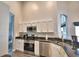 Modern kitchen with stainless steel appliances and white cabinets at 1932 Southern Dunes Blvd, Haines City, FL 33844