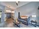 Living room with gray walls, wood-look floors, and leather couch at 1932 Southern Dunes Blvd, Haines City, FL 33844