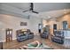 Open living area with gray walls, hardwood floors, and comfortable seating at 1932 Southern Dunes Blvd, Haines City, FL 33844
