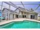 Relaxing pool area with screened enclosure at 1932 Southern Dunes Blvd, Haines City, FL 33844