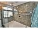 Large walk-in shower with marble tile and built-in shelving at 1932 Southern Dunes Blvd, Haines City, FL 33844