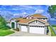 Two-story house with a large yard, lake view and a two-car garage at 2119 Kirkland Lake Dr, Auburndale, FL 33823
