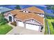 Two-story house with a two-car garage, lake view and a large backyard at 2119 Kirkland Lake Dr, Auburndale, FL 33823
