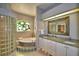 Spa-like bathroom with double vanity, soaking tub, and glass block shower at 2119 Kirkland Lake Dr, Auburndale, FL 33823