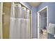 Bathroom with shower/tub combo and tiled walls at 2119 Kirkland Lake Dr, Auburndale, FL 33823