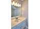Clean bathroom vanity with single sink and updated light fixture at 2119 Kirkland Lake Dr, Auburndale, FL 33823