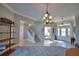 Bright and spacious entryway with staircase and view into dining room at 2119 Kirkland Lake Dr, Auburndale, FL 33823