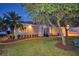 Well-maintained house with a landscaped yard and walkway at night at 2119 Kirkland Lake Dr, Auburndale, FL 33823