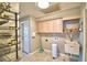 Laundry room with utility sink, cabinets, and storage shelving at 2119 Kirkland Lake Dr, Auburndale, FL 33823