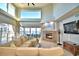Living room features a fireplace, sectional sofa, and water views at 2119 Kirkland Lake Dr, Auburndale, FL 33823