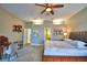 Main bedroom with large bed, sitting area, and ensuite bath at 2119 Kirkland Lake Dr, Auburndale, FL 33823