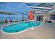 Inviting kidney-shaped pool with a covered patio and lake view at 2119 Kirkland Lake Dr, Auburndale, FL 33823