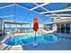 Inviting pool area with lake view and red umbrella at 2119 Kirkland Lake Dr, Auburndale, FL 33823