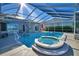 Relaxing pool and spa with covered lanai overlooking the lake at 2119 Kirkland Lake Dr, Auburndale, FL 33823