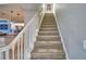 Elegant staircase with white railings and carpeted steps leading to the upper level at 2119 Kirkland Lake Dr, Auburndale, FL 33823