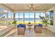 Bright sunroom boasts water views and comfortable seating at 2119 Kirkland Lake Dr, Auburndale, FL 33823