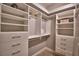 Well-organized walk-in closet with drawers and hanging space at 2119 Kirkland Lake Dr, Auburndale, FL 33823