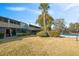 Community backyard with a swimming pool and lush lawn at 2500 21St Nw St # 22, Winter Haven, FL 33881