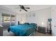 Bright bedroom with a queen bed, ceiling fan, and access to a balcony at 2500 21St Nw St # 22, Winter Haven, FL 33881