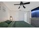 Spacious bedroom with a king-size bed, ceiling fan, and en-suite bathroom at 2500 21St Nw St # 22, Winter Haven, FL 33881