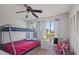 Bedroom with a bunk bed, ceiling fan, and large window at 2500 21St Nw St # 22, Winter Haven, FL 33881