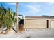 Tan double garage doors with walkway to entrance at 2500 21St Nw St # 22, Winter Haven, FL 33881