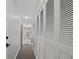 Clean hallway with white doors and access to laundry at 2500 21St Nw St # 22, Winter Haven, FL 33881