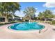 Relaxing kidney-shaped pool with surrounding patio furniture at 2500 21St Nw St # 22, Winter Haven, FL 33881