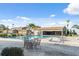 Community pool with patio tables and chairs at 2500 21St Nw St # 22, Winter Haven, FL 33881
