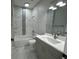 Bright bathroom with gray vanity, marble tile, and shower over tub at 2510 Lakefront Dr, Lake Wales, FL 33898