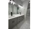 Bright bathroom features double vanity, sleek fixtures, and modern tile flooring at 2510 Lakefront Dr, Lake Wales, FL 33898